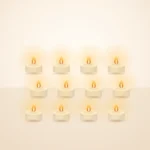Twelve flameless LED tealights glowing warm